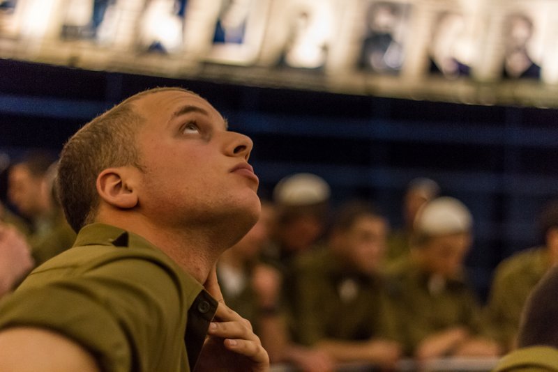 Yad Vashem soldier looks at photos